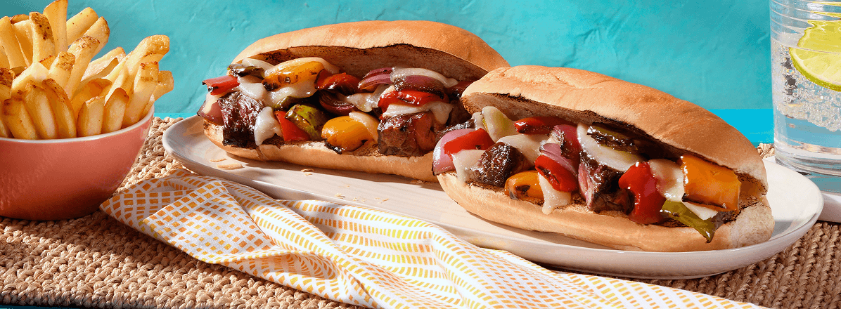 Two Philly Cheesesteak beef kabob sandwiches with side of fries