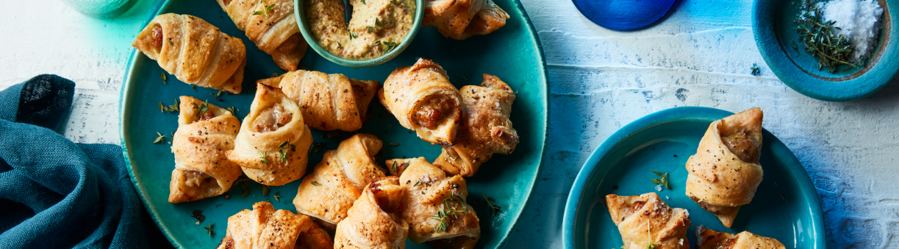 Pigs in a blanket in a turquoise plate