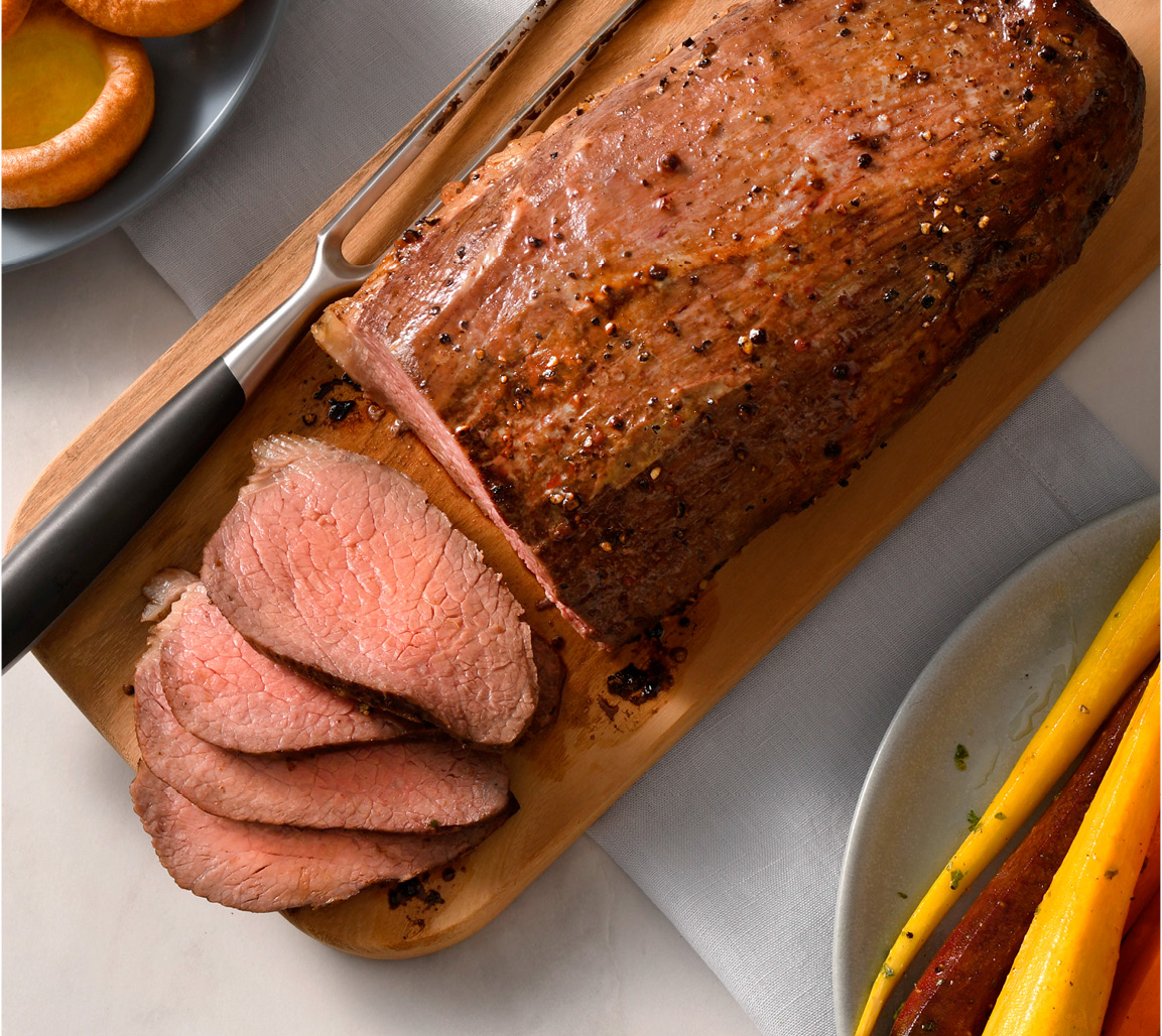 Overhead shot of sliced eye of the round roast on cutting board