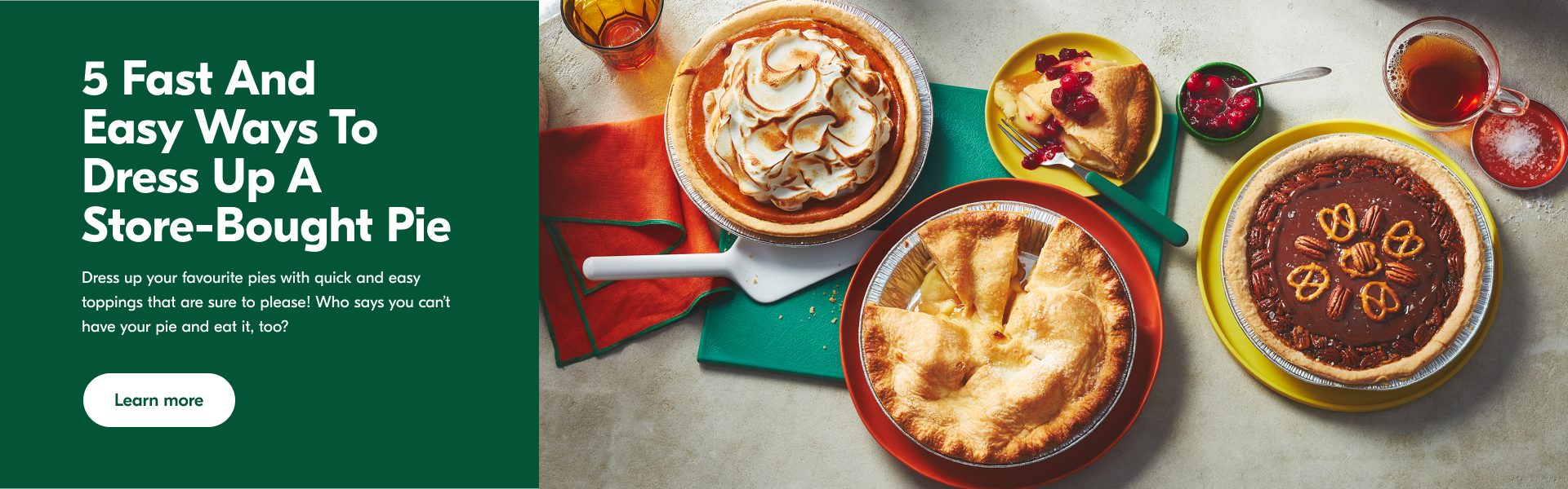 A pumpkin meringue pie, salted dark chocolate and pretzel pecan pie and apple pie on a blue chopping board.