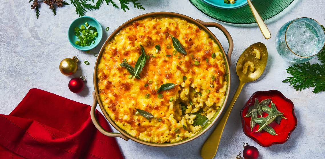 Overhead shot of baked three cheese mac and cheese topped with fried sage