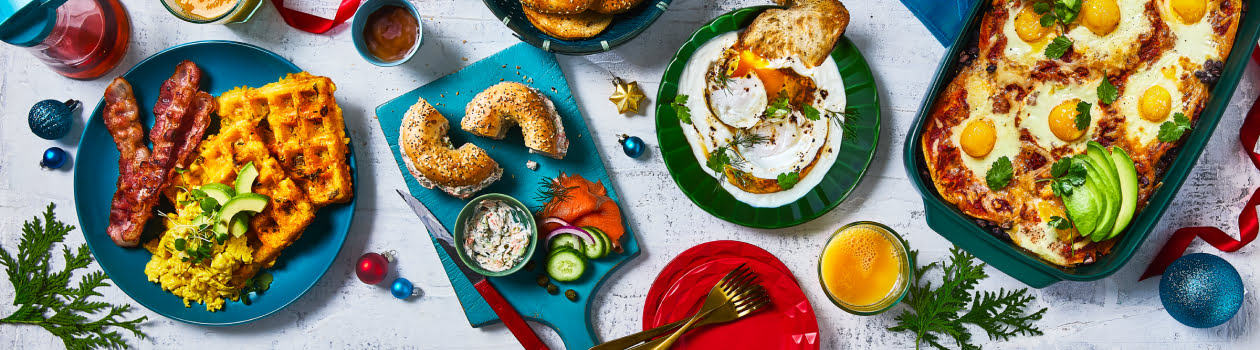 Overhead shot of trendy brunch dishes like tater tot waffles, chopped bagels, Turkish eggs and the Huevos Rancheros Breakfast Casserole