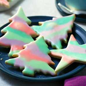 Sugar cookies with paintbrush icing on a blue plate