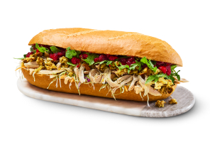 Whole Festive Chicken Dagwood Sandwich on white background.