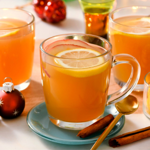 Maple caramel cider toddy in three glass mugs on a round serving platter