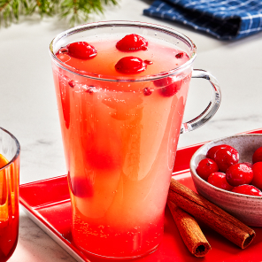 Pineapple panache in a tall glass mug on a red serving tray