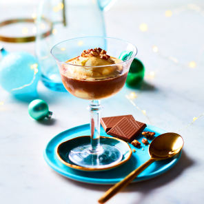 Rye affogato in a tall drinking glass on a blue plate