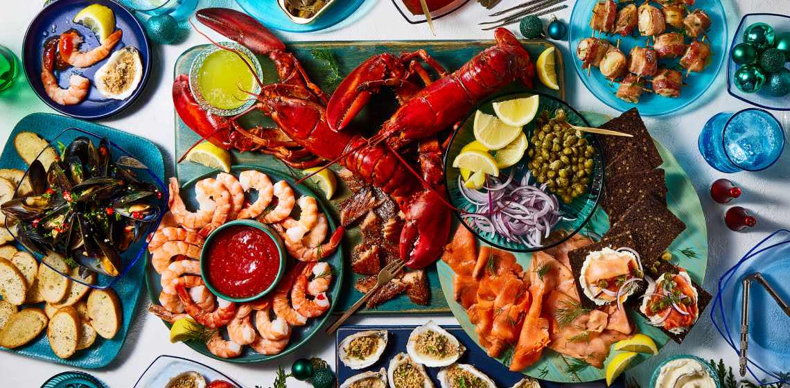 Overhead shot of seafood board with lobster, shrimp, oysters and more.