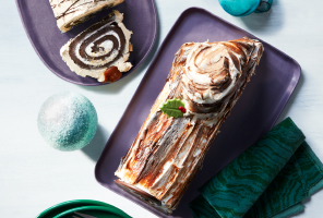 Overhead shot of chocolate and vanilla yule log cakes
    