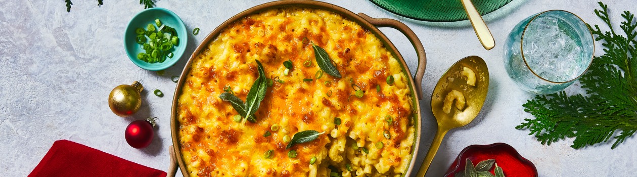 Overhead shot of baked three cheese mac and cheese topped with fried sage