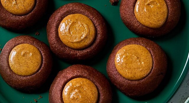 Overhead shot of the thumbprint cookies on a green plate