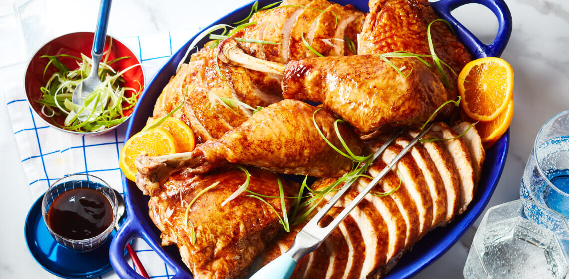 Carved citrus and spice glazed turkey on a serving platter