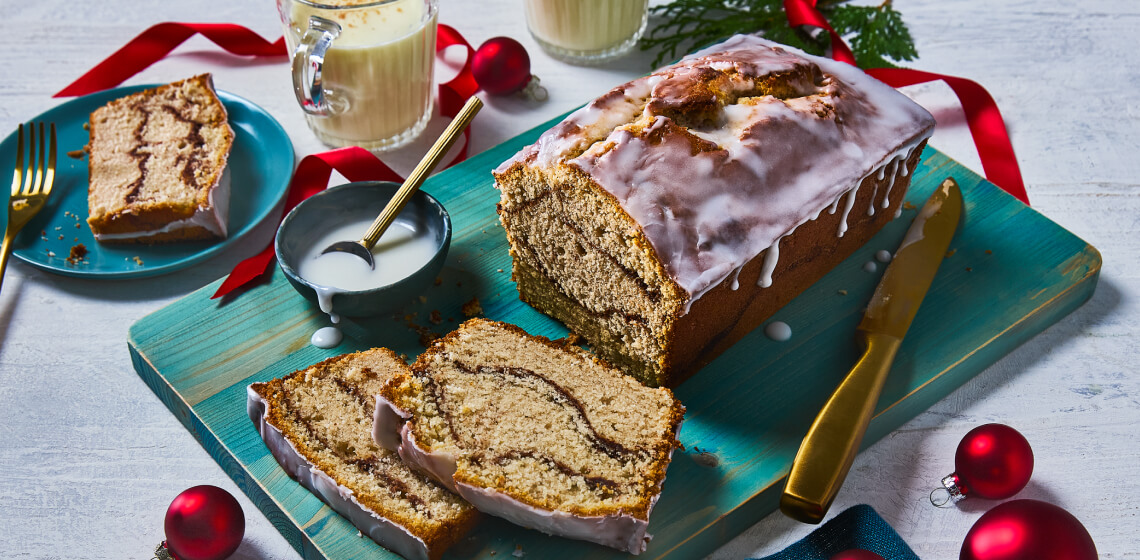 Sliced eggnog loaf cake on a cutting board