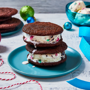 Two ice cream sandwiches stacked on top of each other on a blue plate