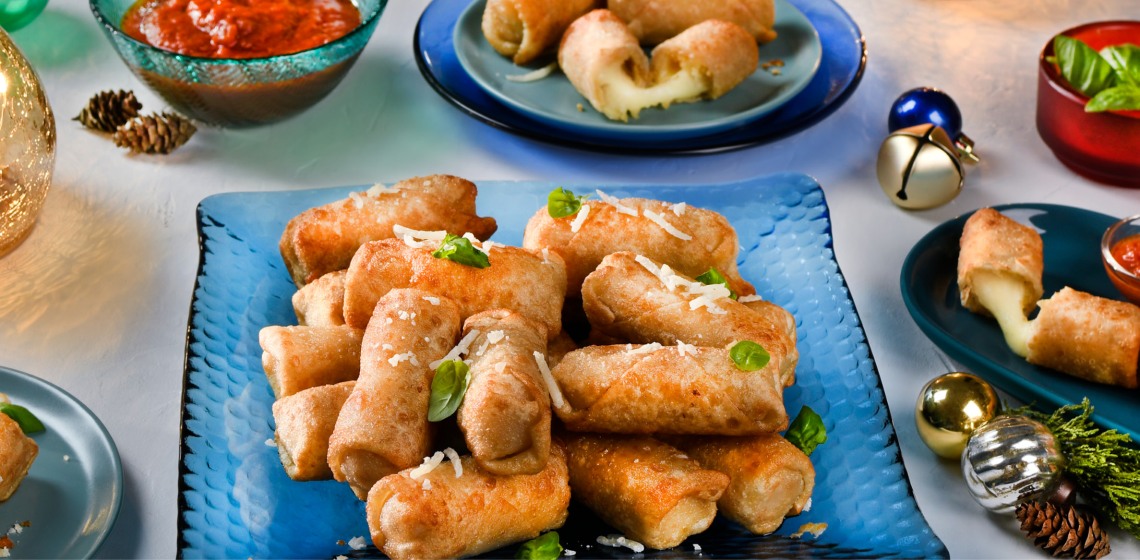 Wonton mozzarella sticks on a square blue plate