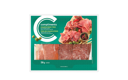 Clear plastic package of Compliments Charcuterie Trio (Dry-Cured Genoa Salami, Salami with Prosciutto & Prosciutto) with green label.