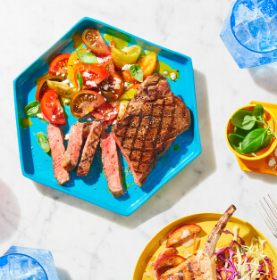 Marble surface topped with blue platter of Sterling Silver Striploin Grilling Steak